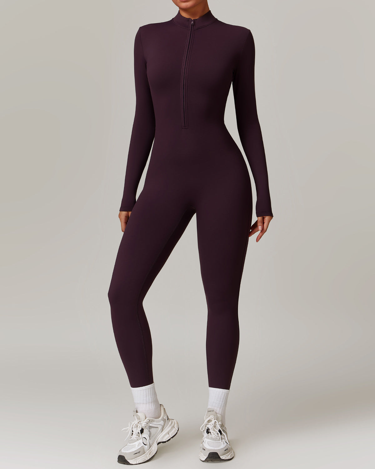 Woman in a zip-front yoga jumpsuit