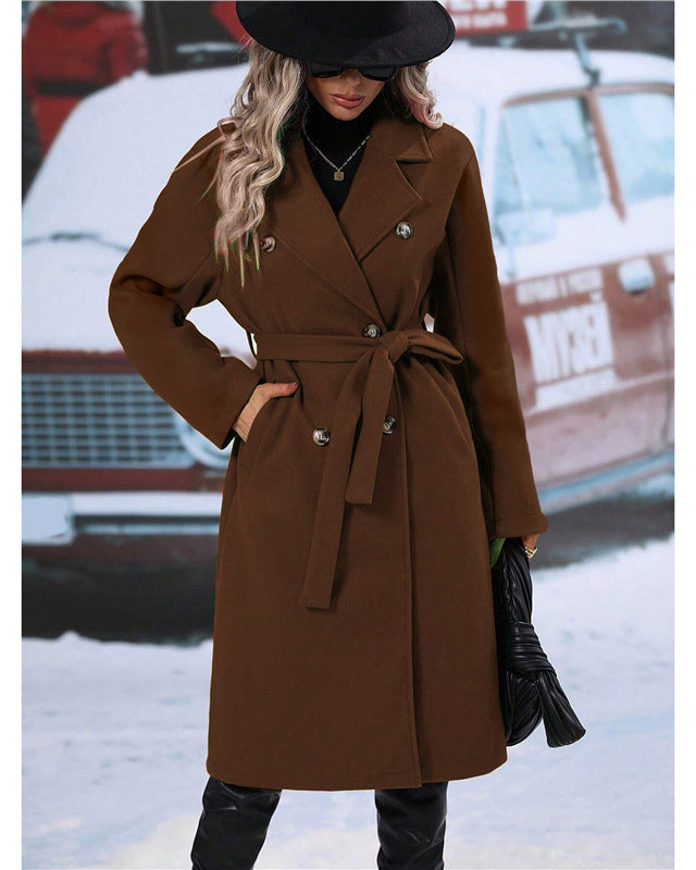 Woman in long belted double-breasted coat