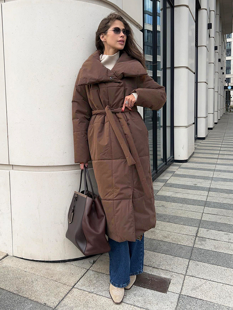 Woman in a long quilted belted coat